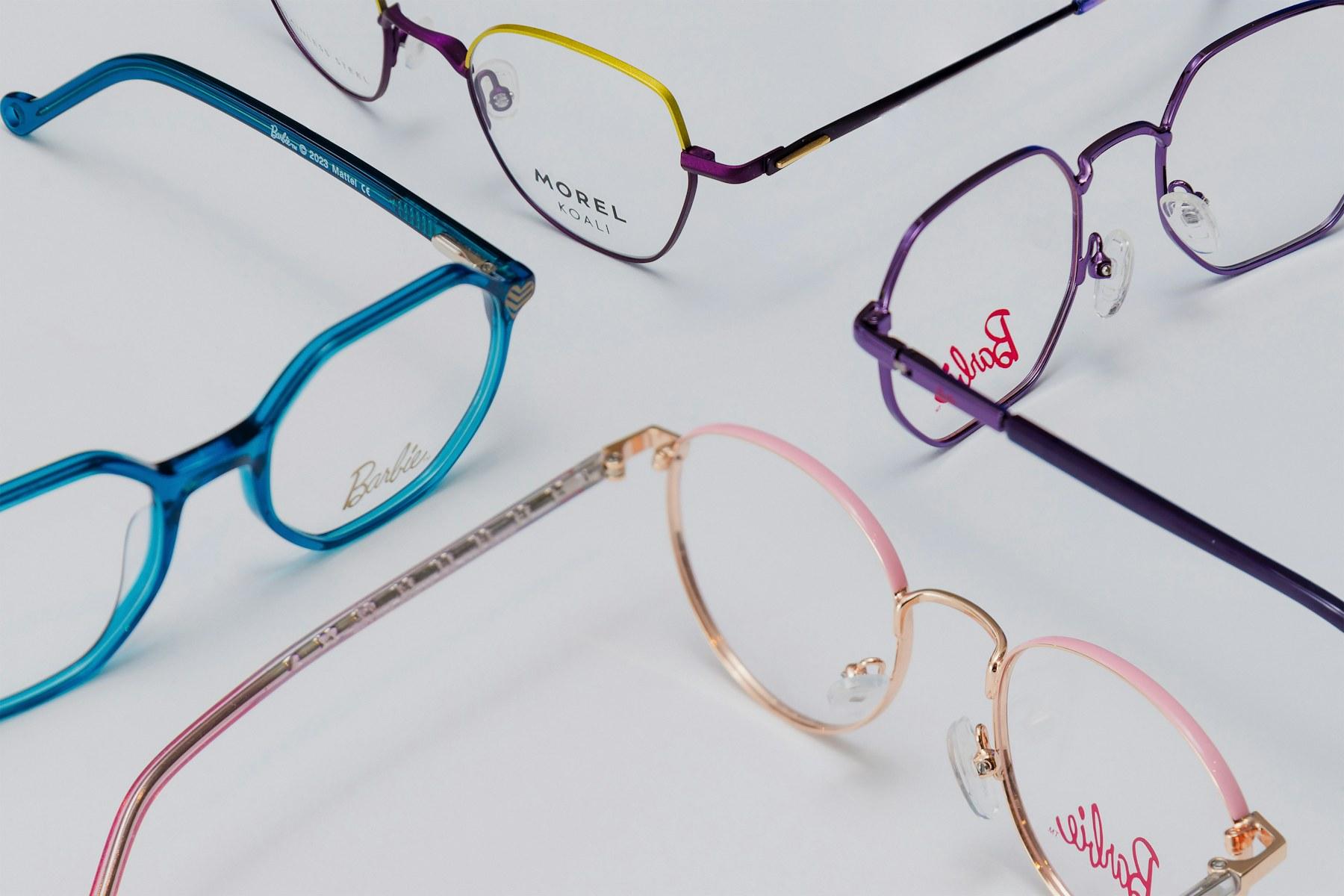 An assortment of eyeglass frames laid out on a white surface